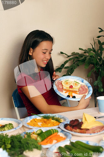 Image of Girl having fun with her food
