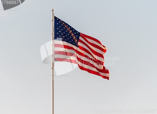 Image of American Flag Flying in front of a clear sky