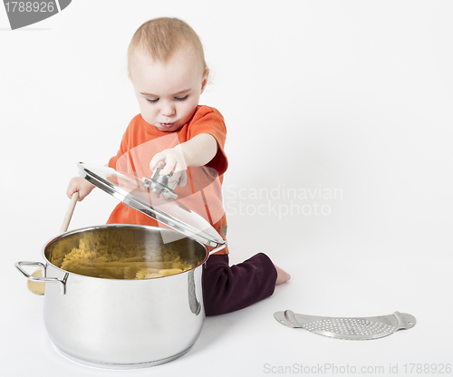 Image of baby with big cooking pot
