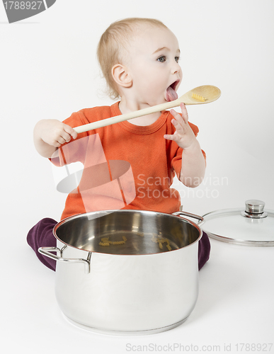 Image of baby with big cooking pot