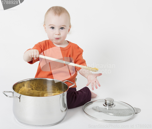 Image of baby with big cooking pot