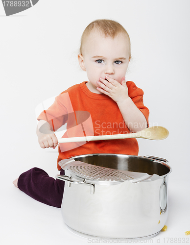 Image of baby with big cooking pot and wooden spoon