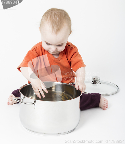 Image of baby with big cooking pot
