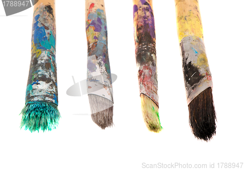 Image of Dirty wooden paint brushes isolated on white 