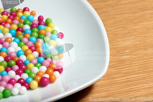 Image of colored sugar balls on a white plate