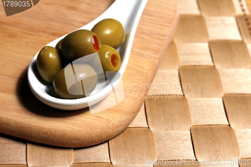 Image of stuffed olives on a porcelain spoon