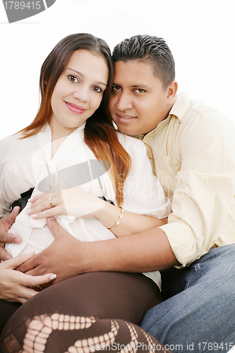 Image of Happy pregnant couple expecting their baby over white