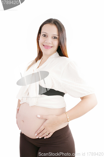 Image of Pregnant happy woman hold her belly with hands looking at camera