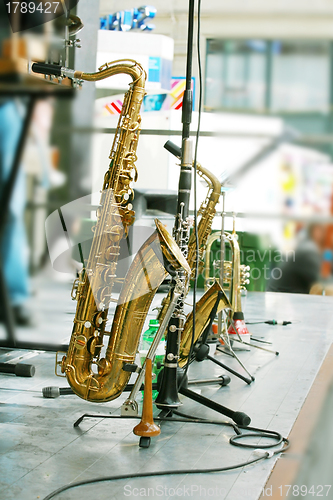 Image of golden saxophone alto on stage 