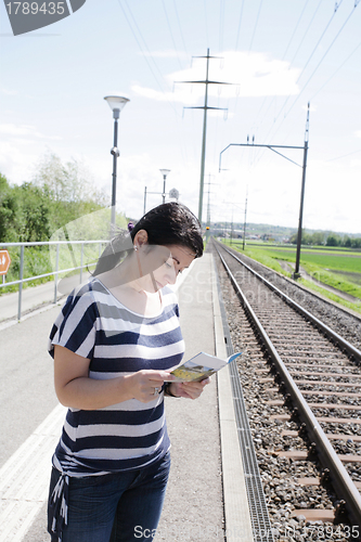 Image of Young female lost looking the map finding the right direction 