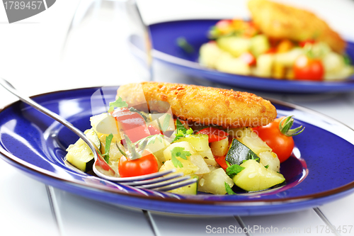 Image of Fried fish on vegetables