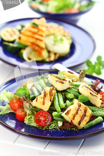 Image of Grilled cheese on green beans with tomatoes