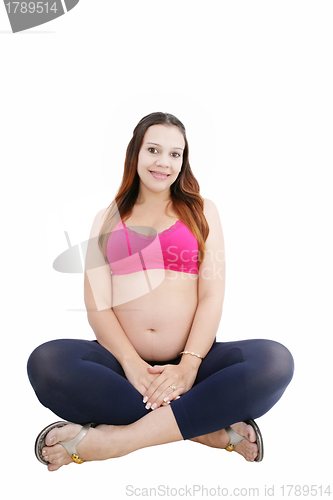 Image of Pregnant woman sitting in floor smiling