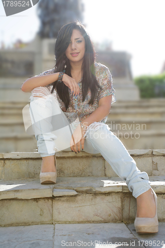 Image of Young woman outdoors portrait. Soft sunny colors.