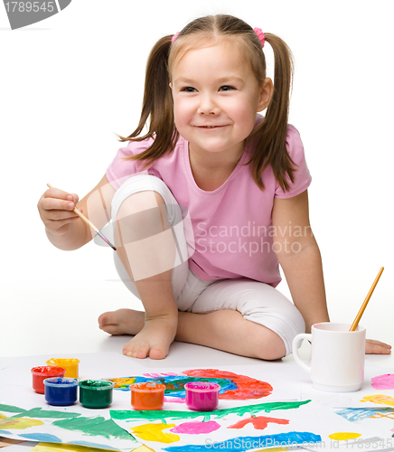 Image of Cute cheerful child play with paints
