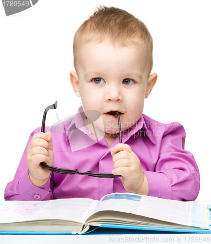 Image of Cute little child play with book