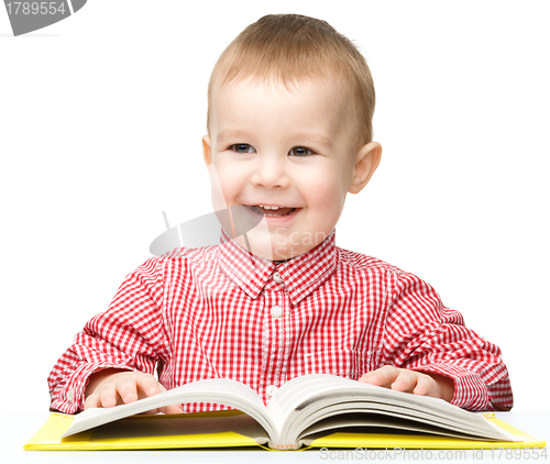 Image of Cute little child play with book