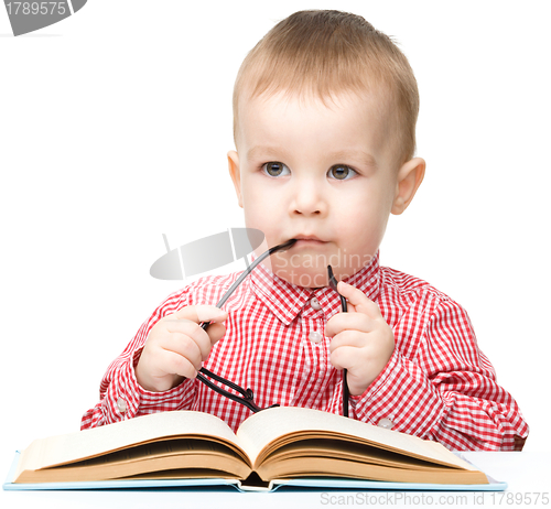 Image of Cute little child play with book