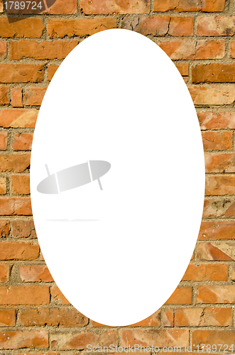 Image of Red brick wall and white oval in center 