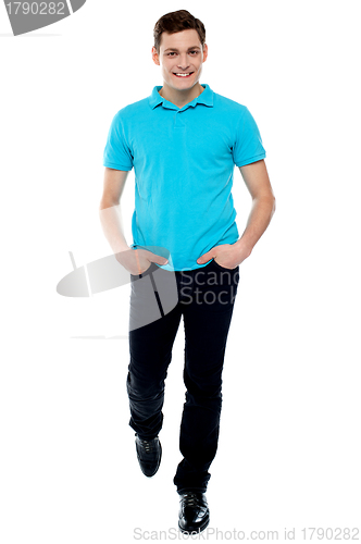 Image of Handsome guy in walking pose. Studio shot