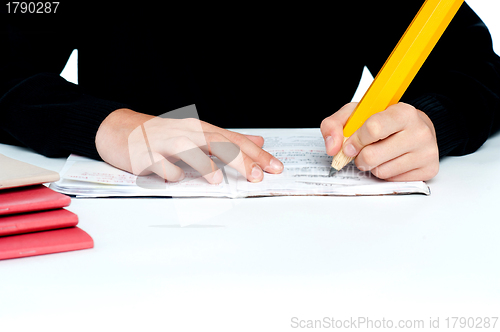 Image of Closeup shot of school boy doing homework