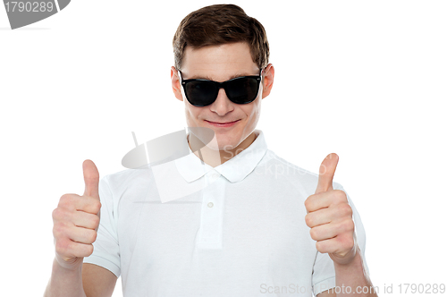 Image of Handsome guy gesturing double thumbs up