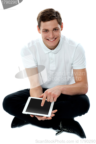 Image of Seated guy with finger on touch pad device