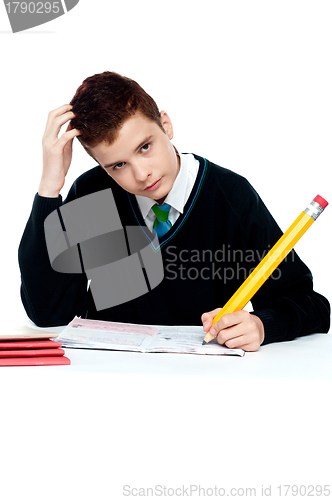 Image of Confused young school boy thinking