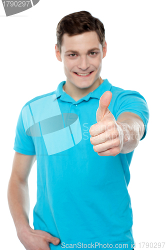 Image of Handsome casual smiling guy showing thumbs up