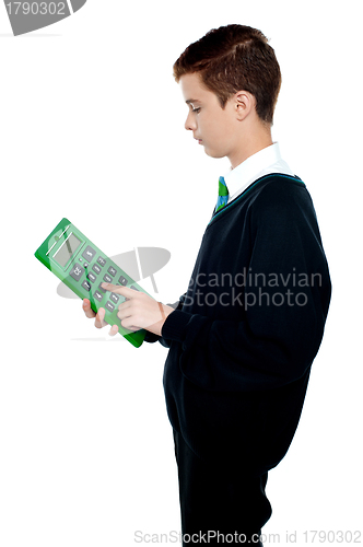 Image of School boy using big green calculator