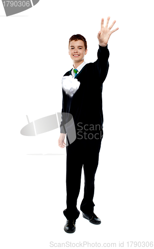 Image of Cheerful young boy throwing paper