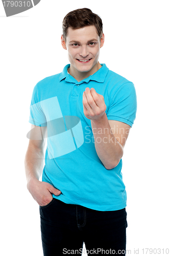 Image of Smart young smiling guy posing in style