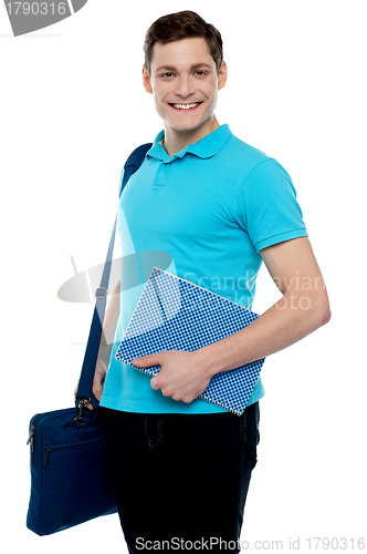 Image of Smiling guy holding notepad and laptop bag