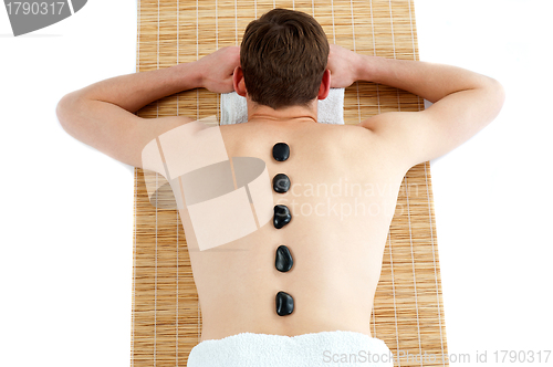 Image of Man receiving hot stone therapy massage