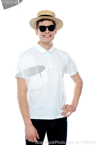 Image of Man smiling with hand on his waist wearing hat