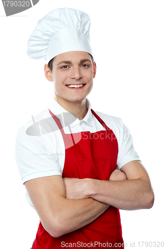 Image of Smiling young chef posing with crossed arms