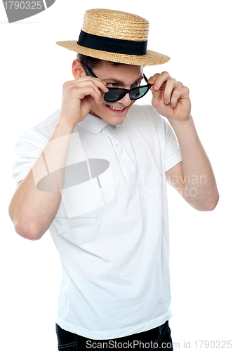 Image of Man looking from behind sunglasses and smiling
