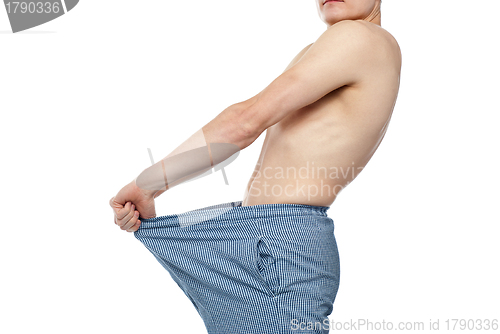 Image of Cropped image of man wearing loose shorts