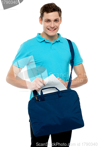 Image of Guy taking out paper from his laptop bag