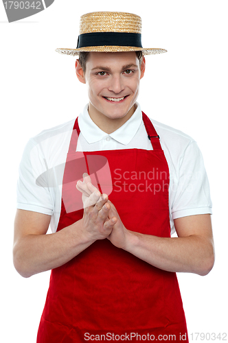 Image of Young male chef wearing hat