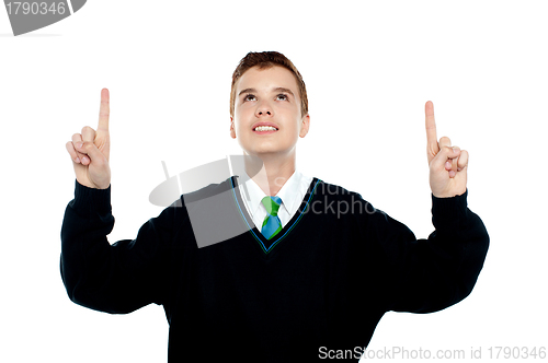 Image of Smiling school kid indicating upwards