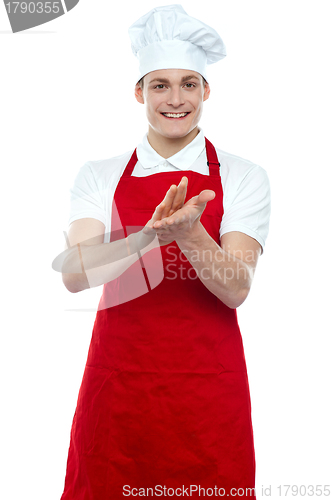 Image of Isolated young handsome male chef clapping