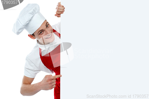 Image of Male chef indicating at blank menu