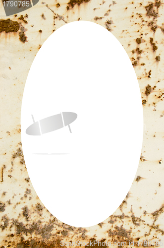 Image of Rusty metal plate  and white oval in center 