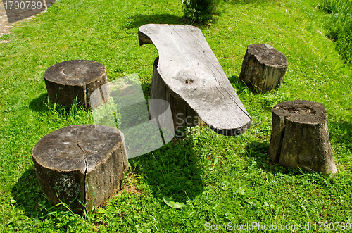 Image of Table and chairs of wood trunk stumps. Rest place 