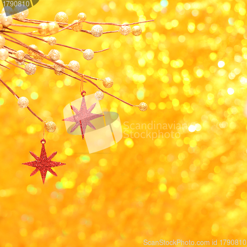 Image of Christmas background with red star and gold glittering bokeh 