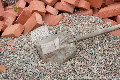 Image of Red clay bricks lying on the gravel