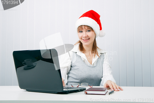 Image of attractive business woman in Christmas hat