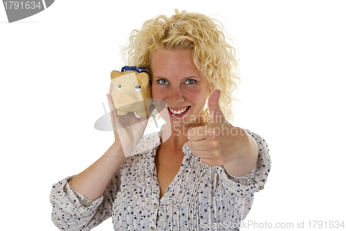 Image of Beautiful young woman with piggy bank