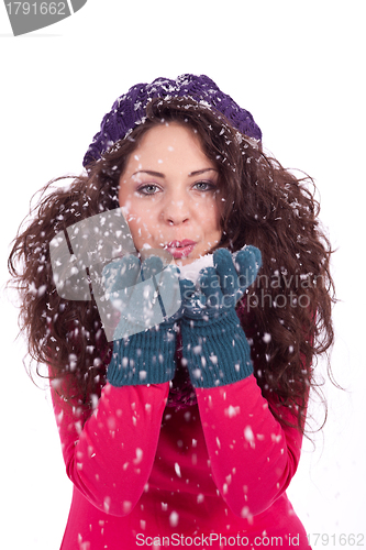 Image of beautiful smiling brunette woman in snow in winter 